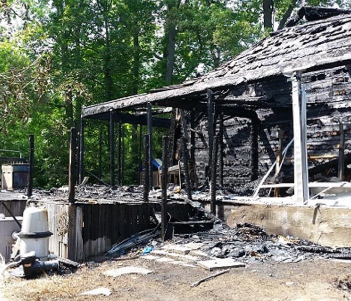 The remains of a house post fire. The debris is visible on the platform. 